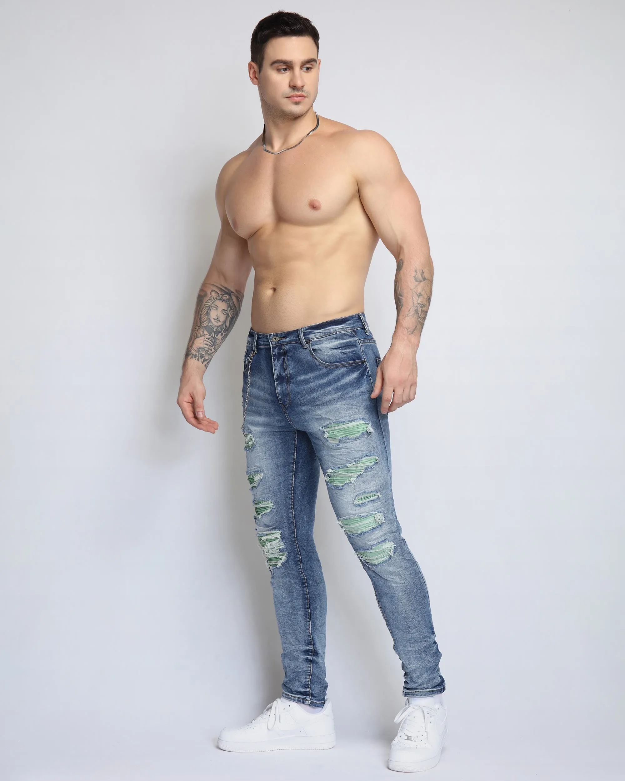 Large Ripped Blue Jeans with Green Patches